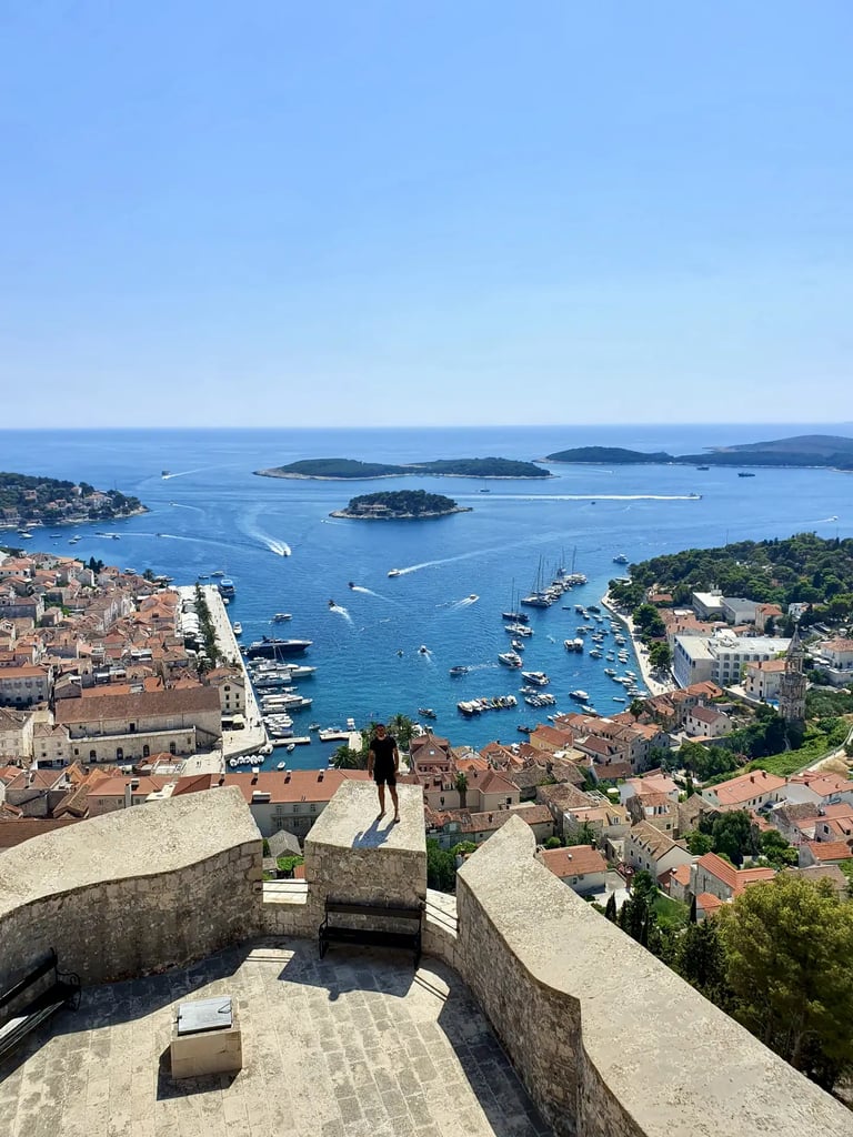 Man at Fortica Fortress in Hvar overlooking Hvar town and Pakleni Islands during private boat tour from Split.