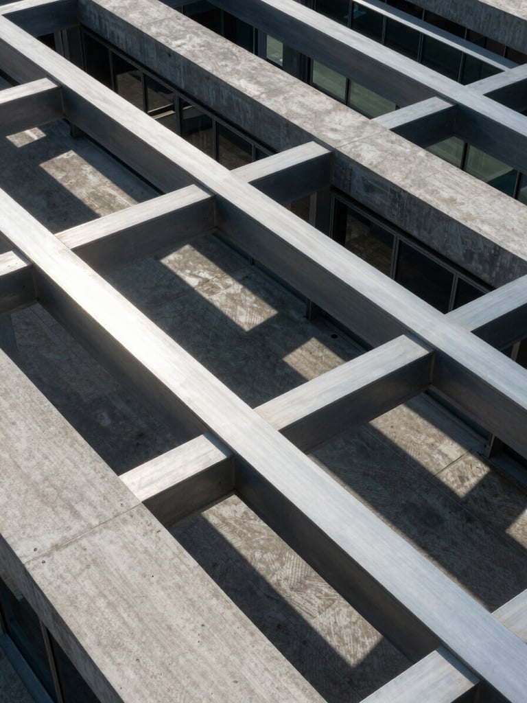 A high-angle architectural shot of a modern corporate office building, clean steel beams, cool daylight casting sharp geometric shadows on concrete.