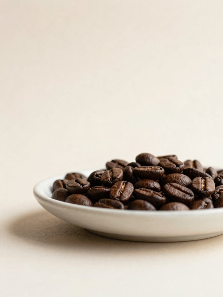 Minimalist close-up of dark roasted coffee beans on a textured off-white ceramic dish, soft natural light, warm earth tones, editorial composition