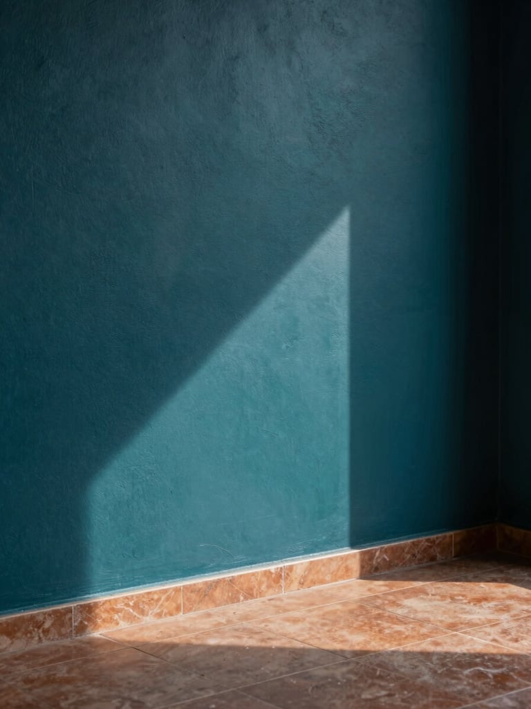 Detail shot of a textured deep teal wall meeting a warm terracotta tile floor inside a modernist Guwahati building, dramatic shadow play.