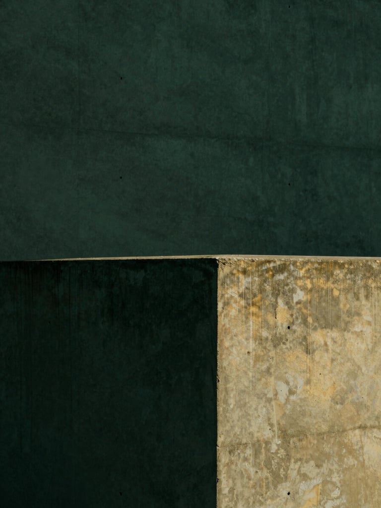 Minimalist architectural photography, sharp direct sunlight with deep shadows on a concrete wall, dark forest green tones, 35mm