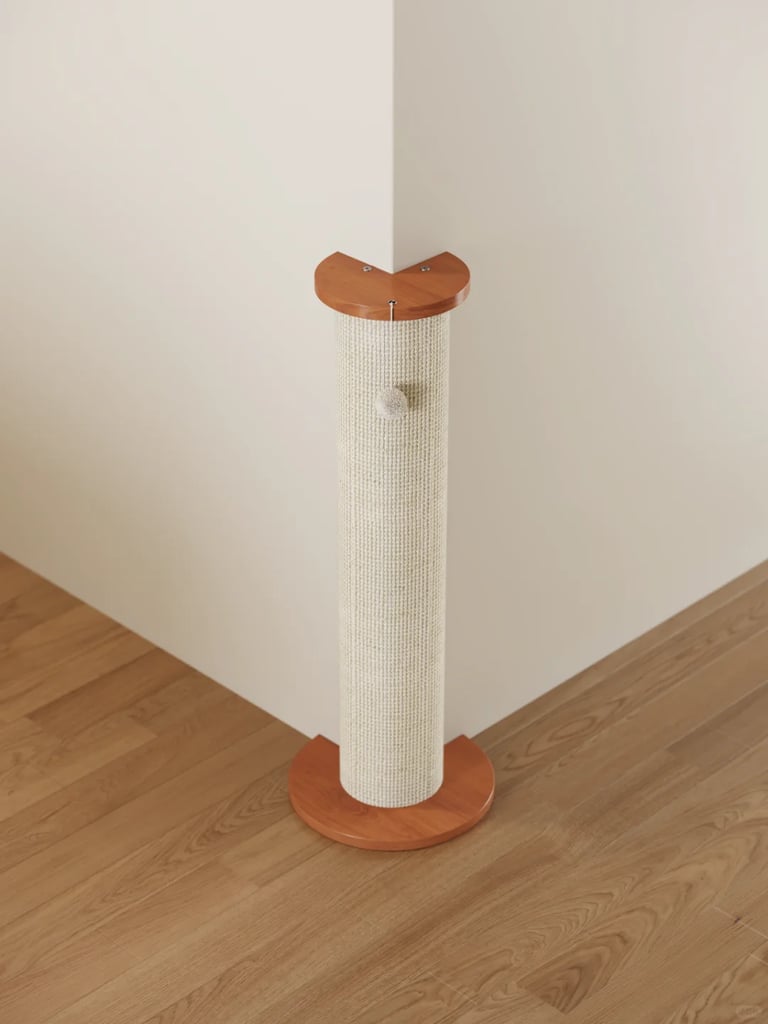 Freestanding sisal cat scratching post with wooden top and base in a clean small apartment corner.