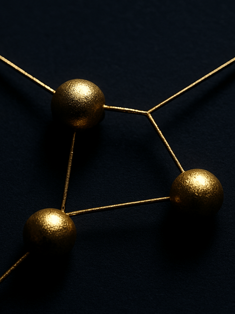 Overhead macro of three interconnected golden geometric nodes on a deep navy surface, fine line paths threading between each node, high-contrast directional studio light illuminating only the node intersections, surrounding field in shadow, no text, no human subjects.