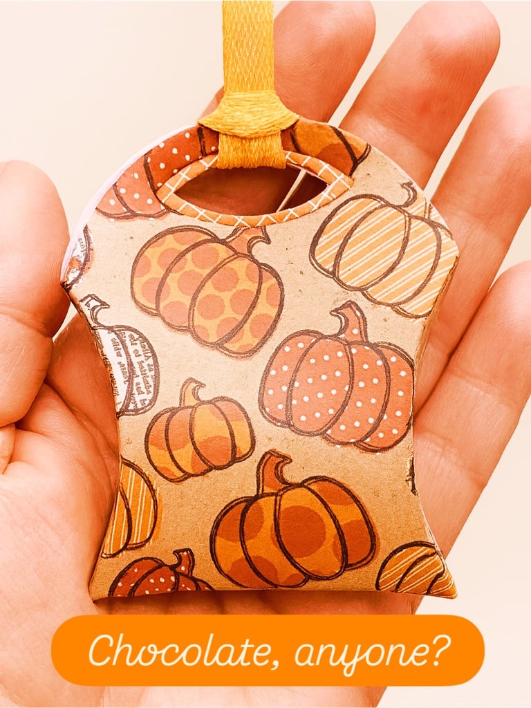 hand holding treat pouch with chocolate