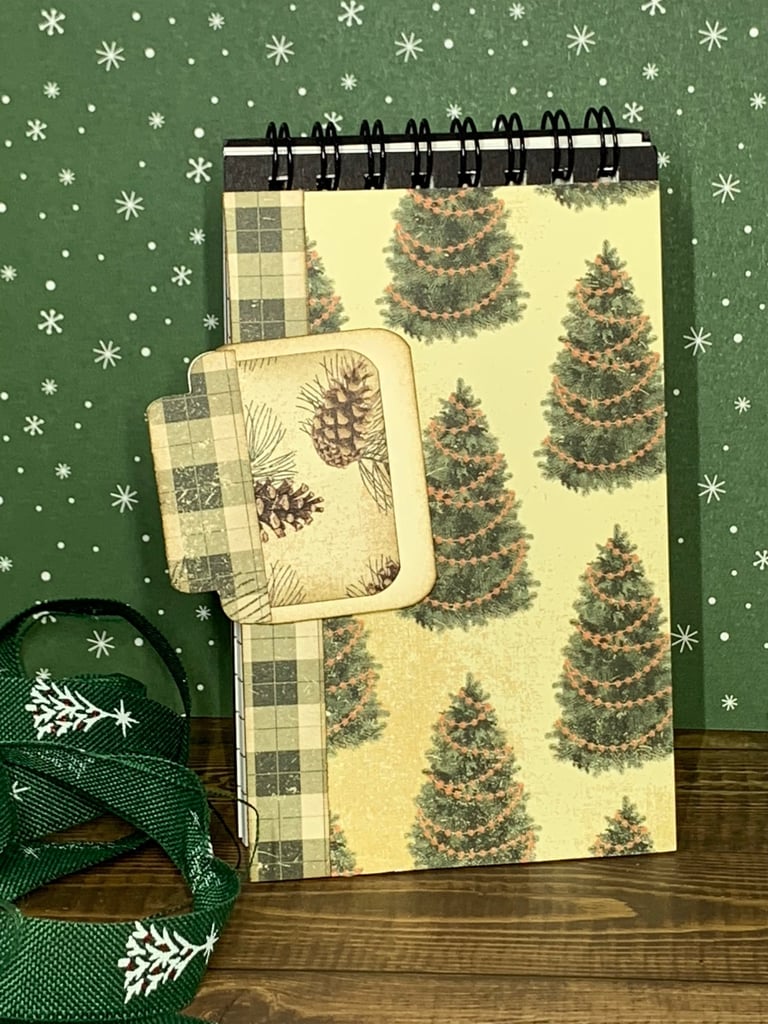 Christmas tree themed covered spiral covered notebook and hidden paper clipan
