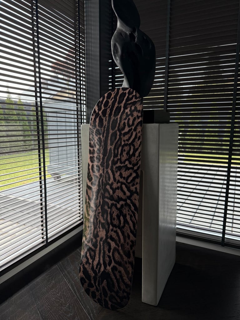 skateboard wall art next to statue