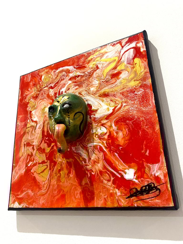 une sculpture avec une longue langue qui émerge d'un tableau rouge vu de côtés