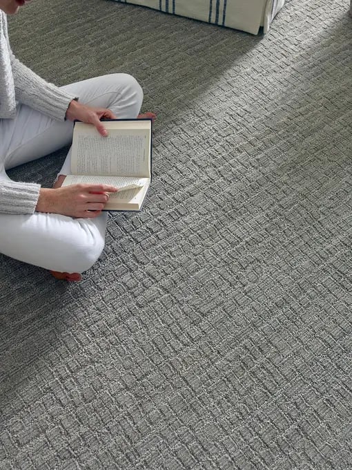 Modern textured design carpet with subtle geometric pattern in neutral tone.