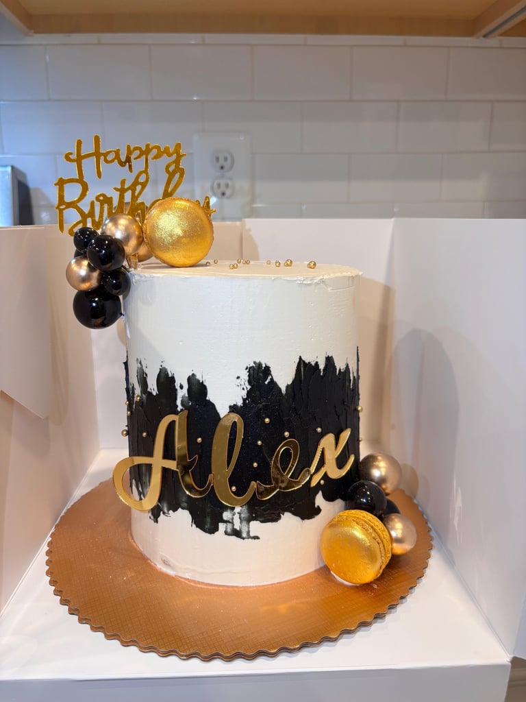 a cake with a gold birthday cake topper