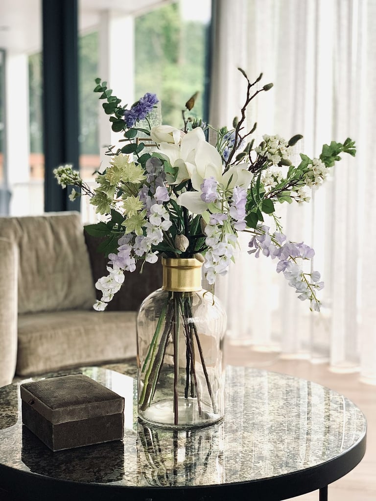 a vase with flowers on a table