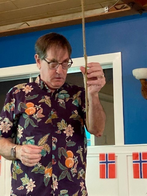 Man staring fiercely at a grafted stick held in front of him