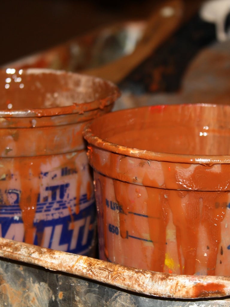 Close up of paint cups in burnt sienna