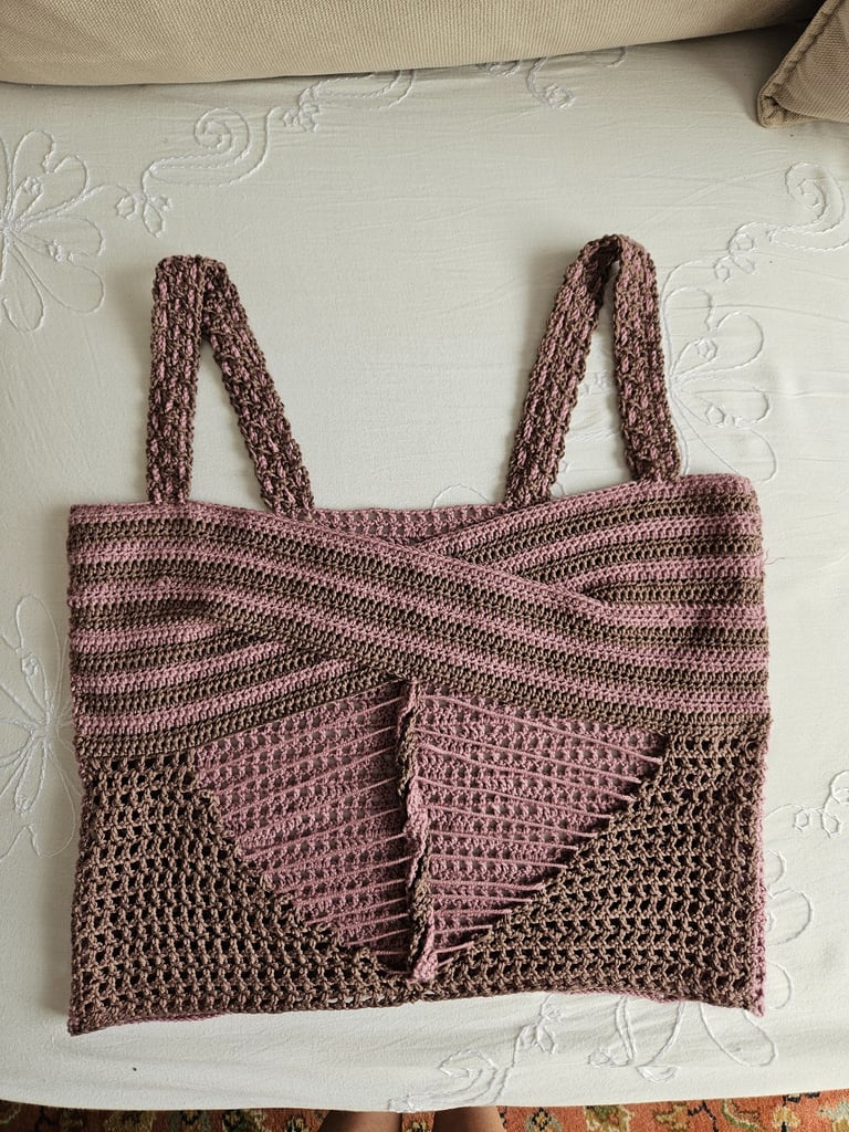 Handmade brown and pink crochet crop top with a cross-over front design and mesh stitch details.