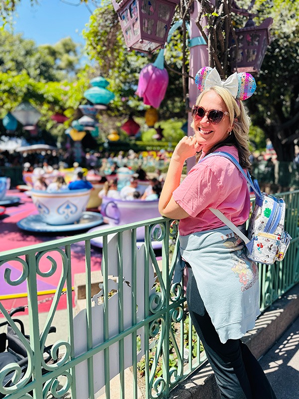Emily Brisson pictured in front of the Mad Tea Party teacups at Disneyland® Park.