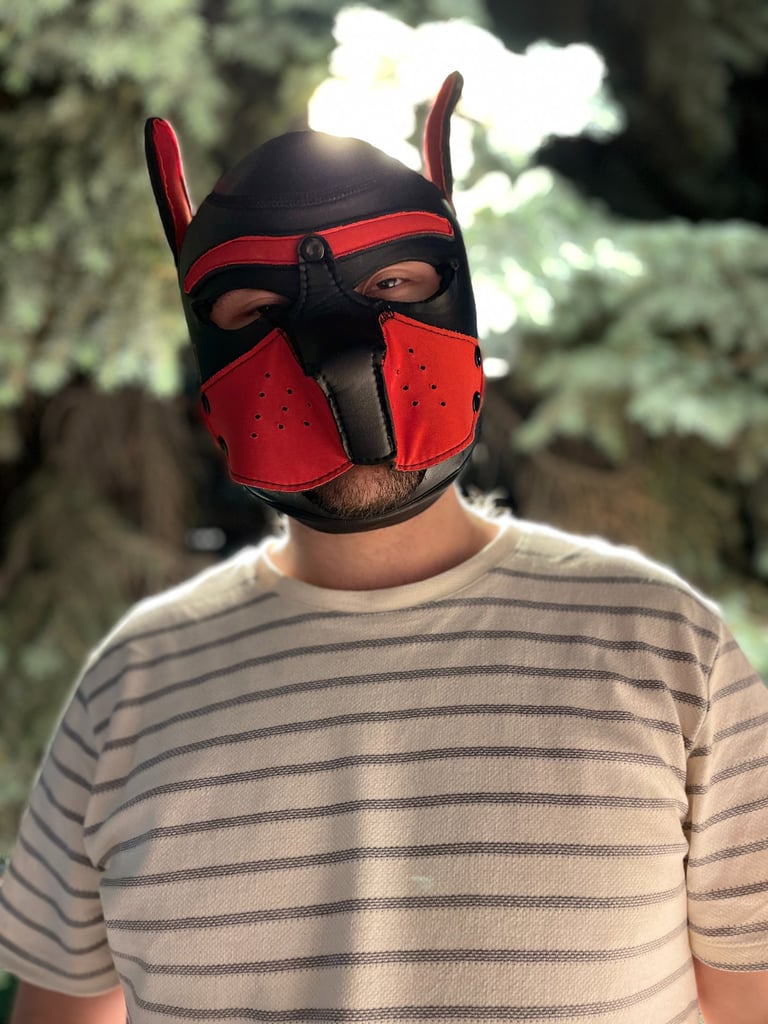 Young man in a pup mask.