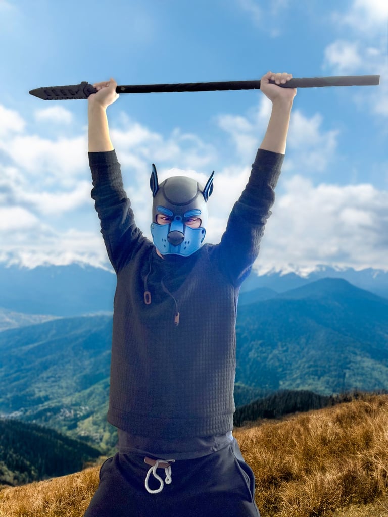 Man posing with staff, wearing pup mask. Original photo altered by ai&me