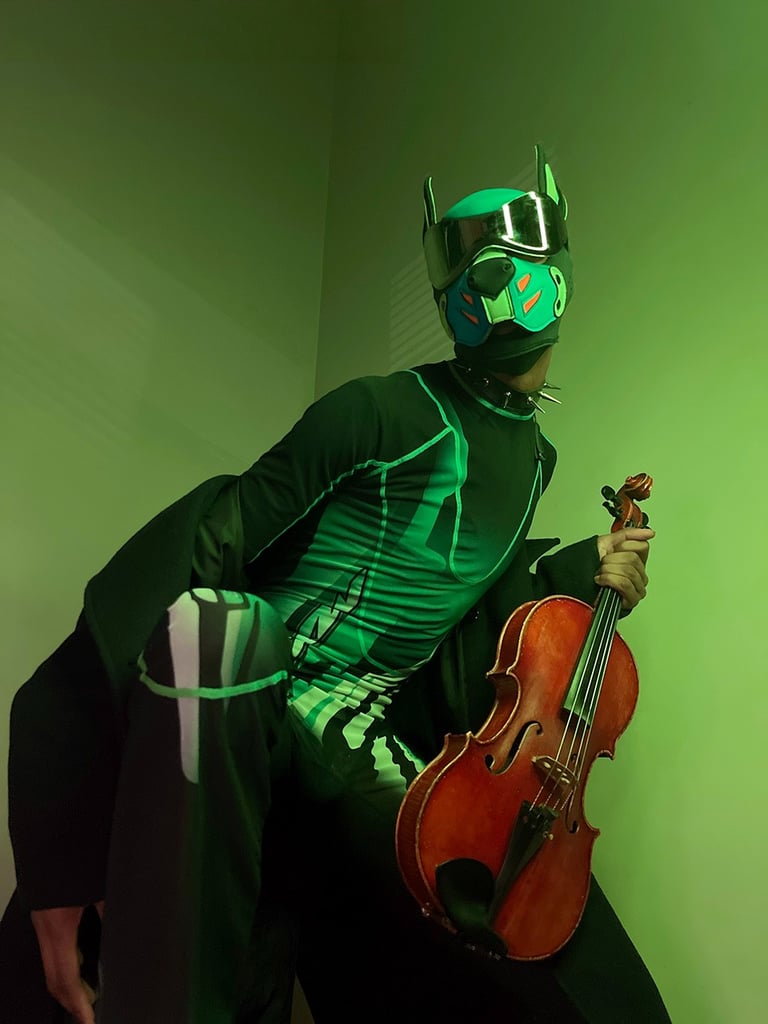 Man in pup mask posing with violin.