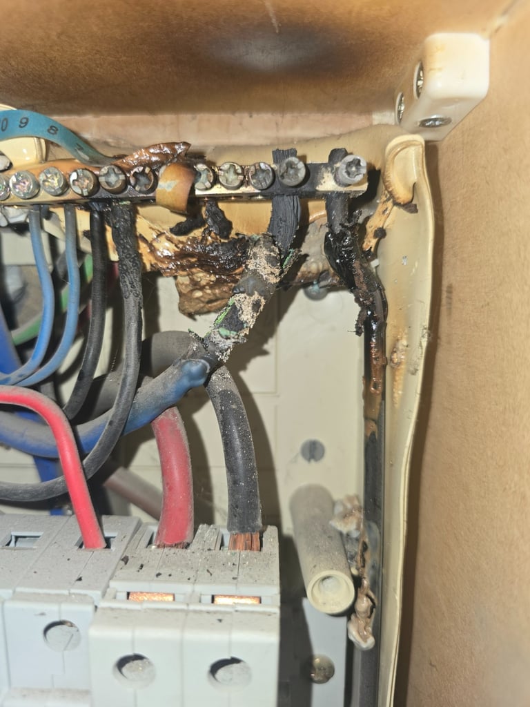 Electrical fault finding revealing overheated wiring and damaged connection inside a consumer unit