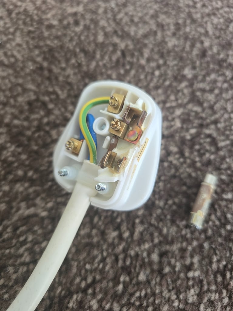 Electrical fault finding revealing overheating damage inside a 13 amp plug caused by a loose connection