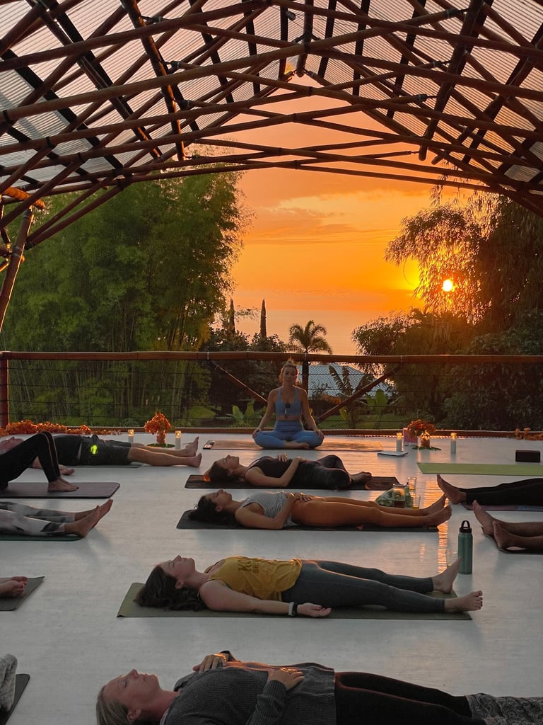 a group of people doing yoga in a large open space