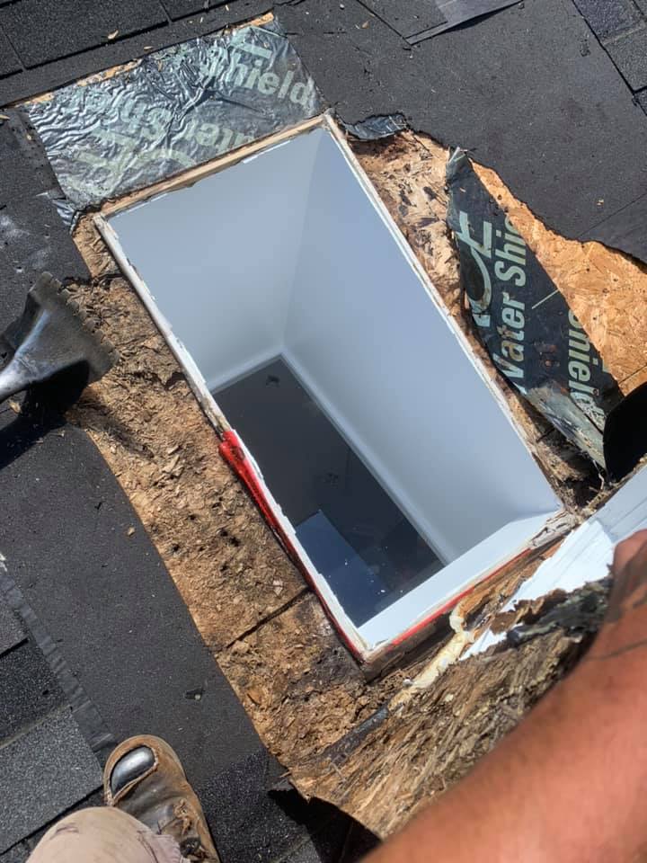 Professional skylight repair on a shingled roof with waterproof ice and water shield membrane.