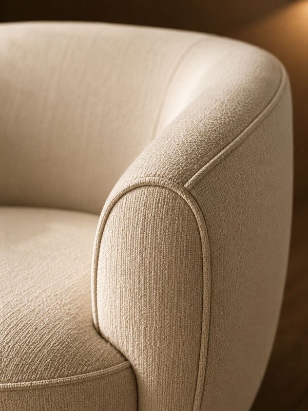 Curved upholstered chair arm detail