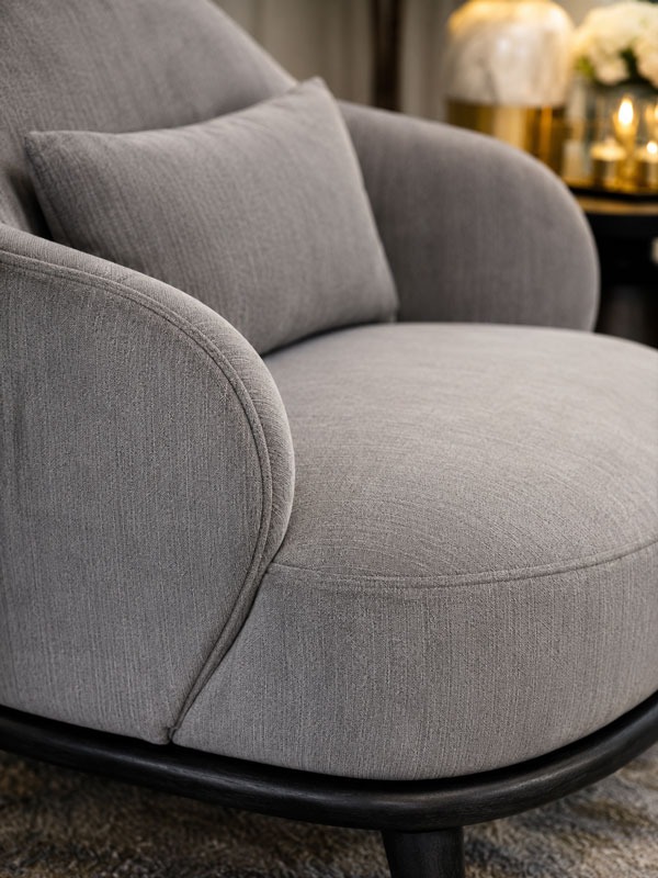 Deep seat detail on a gray upholstered lounge chair
