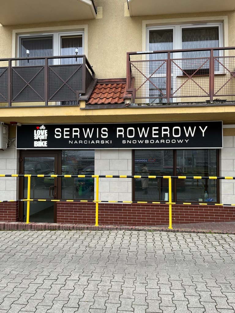 a service bike and snowboard skis center with a sign that says service overcrowing