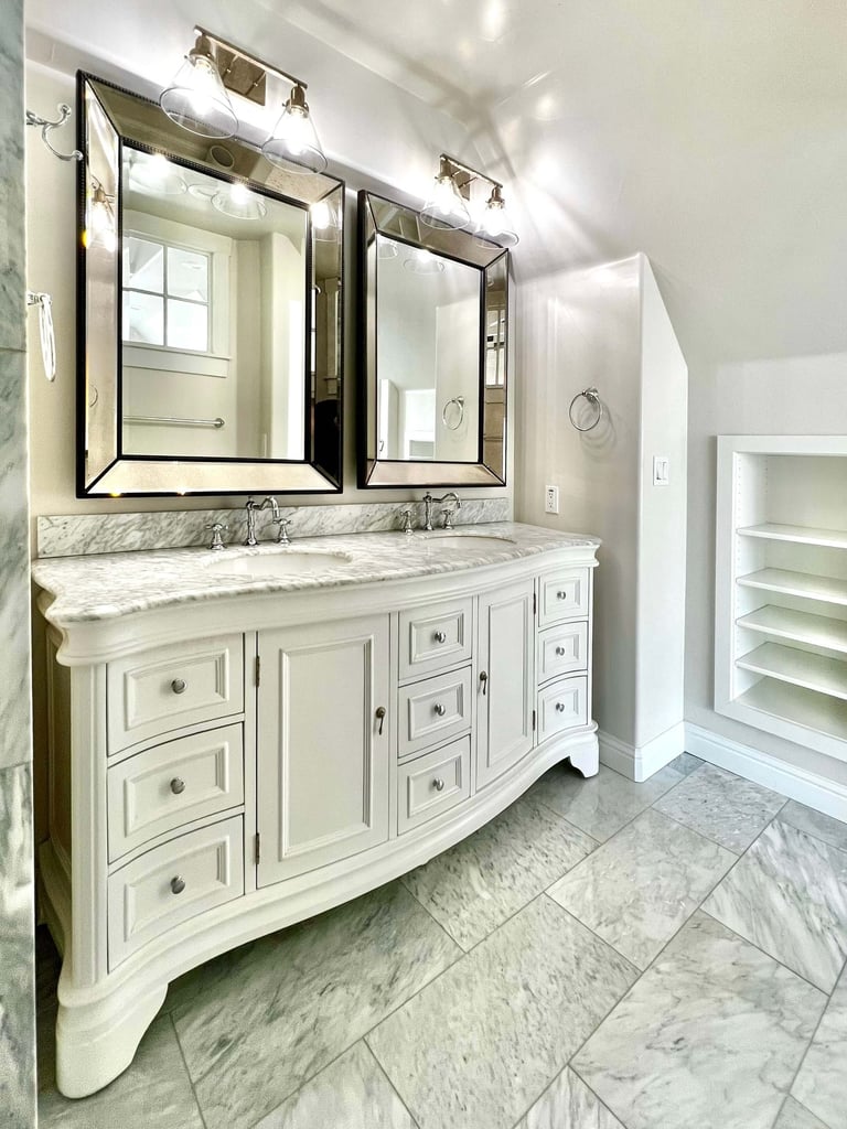 Bathroom with traditional architectural style, beautiful radius wood vanity, and marble countertops.