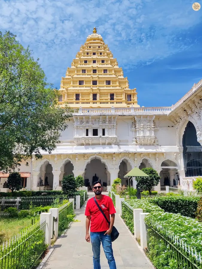 Visitor posing in front of the historic arsenal at Thanjavur Palace, Tamil Nadu