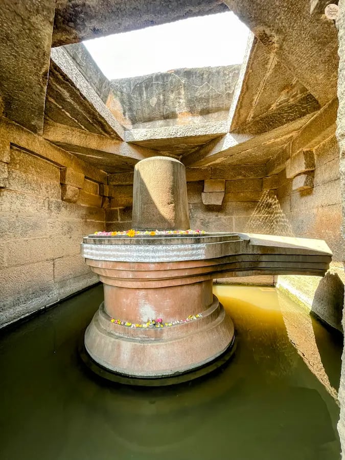 Badavalinga in Hampi, a sacred Shivalinga surrounded by water.