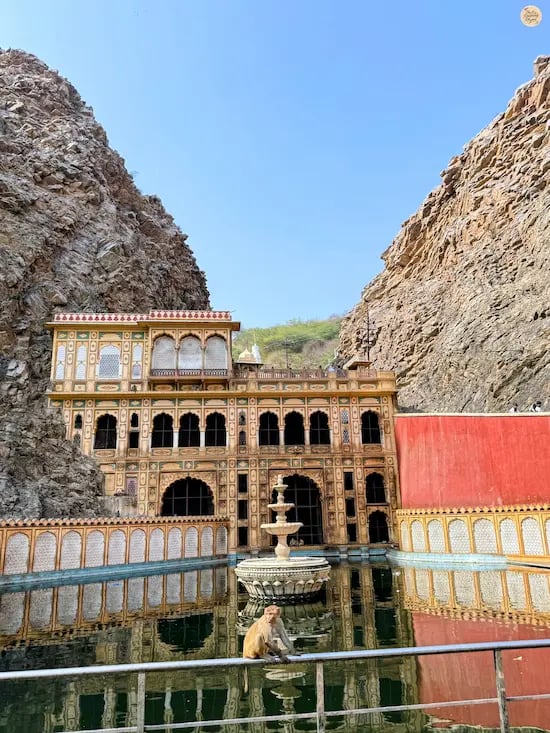 See the sacred kund (pond) at Galta Ji Temple in Jaipur, a historic pilgrimage site surrounded by the Aravalli hills.