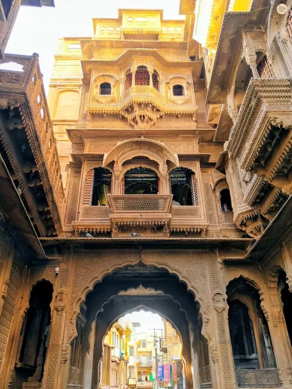 Historic streets with carved balconies and heritage buildings inside Jaisalmer Fort.