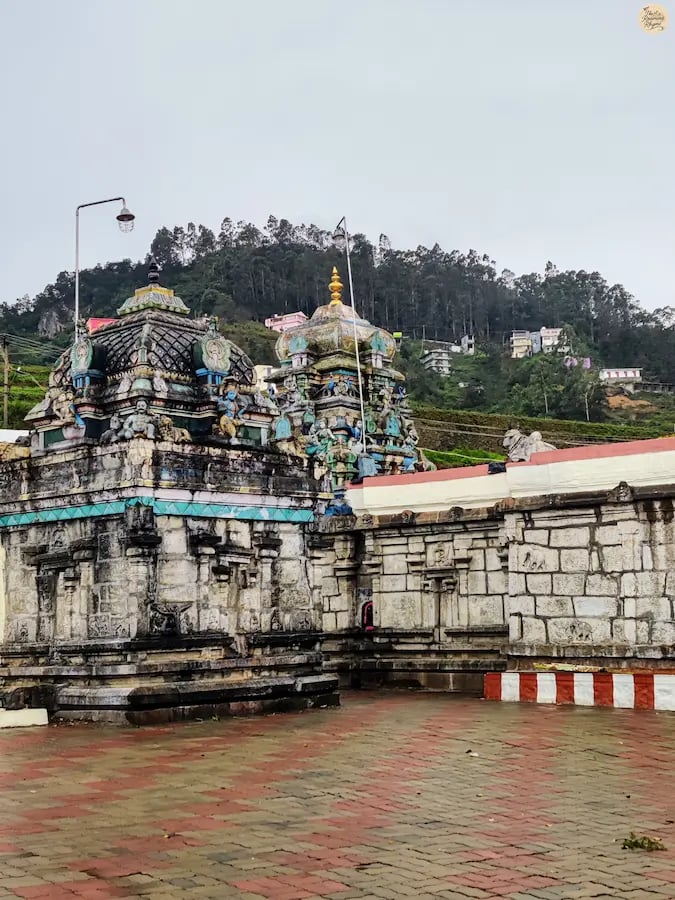 3000-year-old Poombarai Murugan Temple in Kodaikanal surrounded by hills.