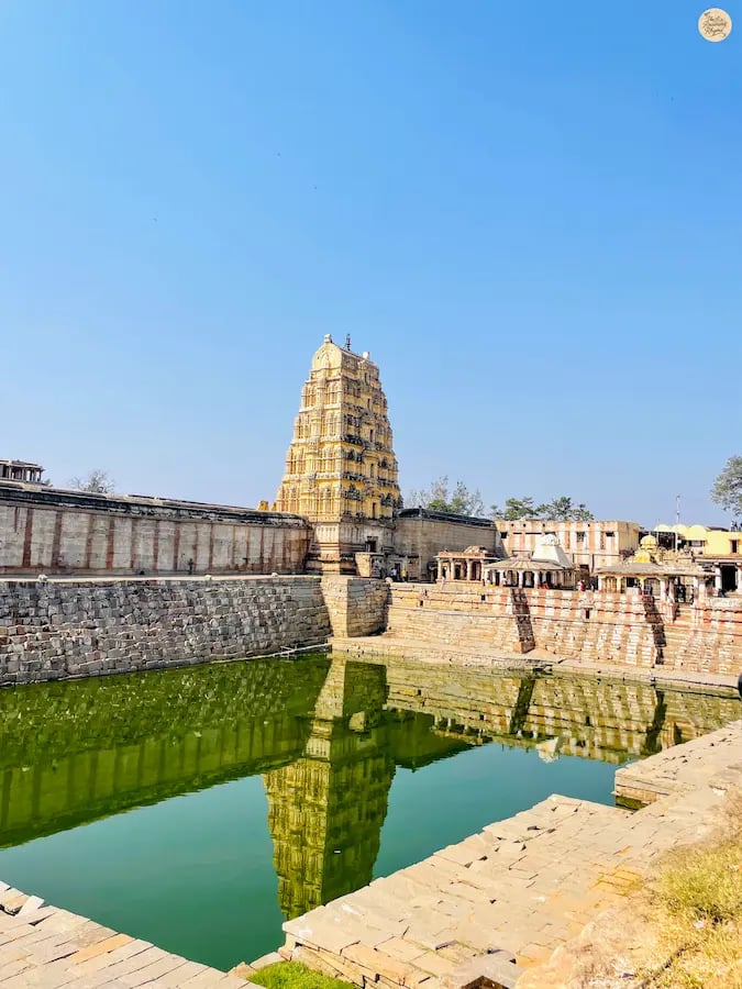 Virupaksha Temple’s Raj Gopuram reflected in the sacred Pushkarni at Hampi.