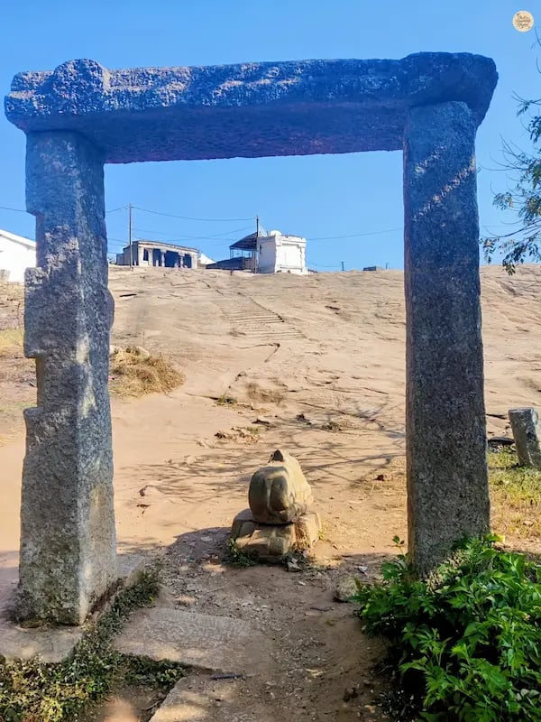 Yoga Nandeeshwara Temple perched at the summit of Nandi Hills, Karnataka, surrounded by rocky terrain and greenery