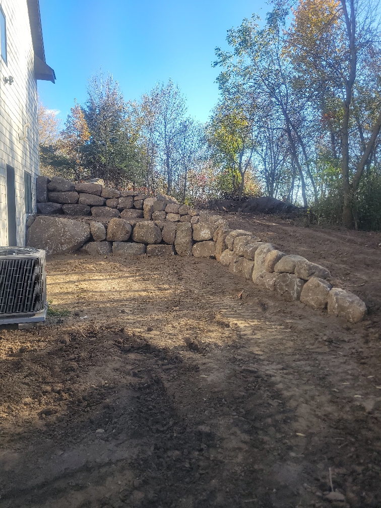 boulder wall next to residential home
