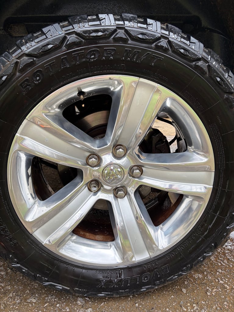 Close-up of a silver five-spoke Ram truck detailing to perfection by mobile detailers