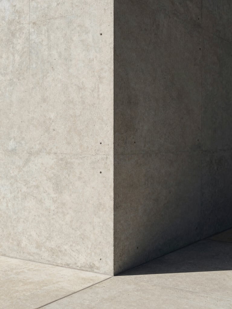 Minimalist architectural corner with sharp shadows and concrete textures, high-contrast natural light, clean editorial framing.