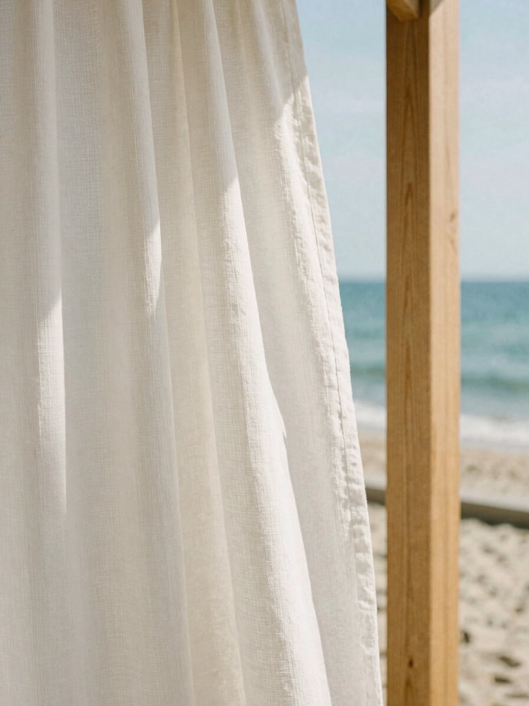 Close-up of textured white linen curtains blowing in a soft coastal breeze, light-colored oak wood details, warm editorial photography, medium format film