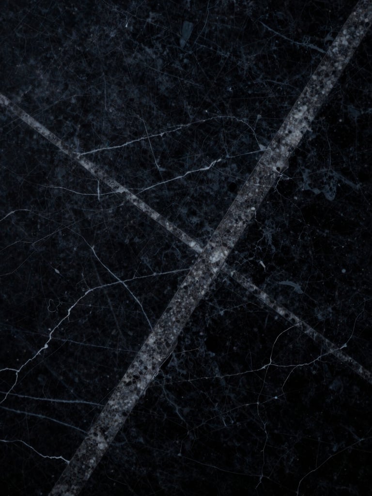 Macro close-up of a dark textured marble slab with sharp geometric veins, dramatic low-key lighting, high-contrast shadows, 35mm
