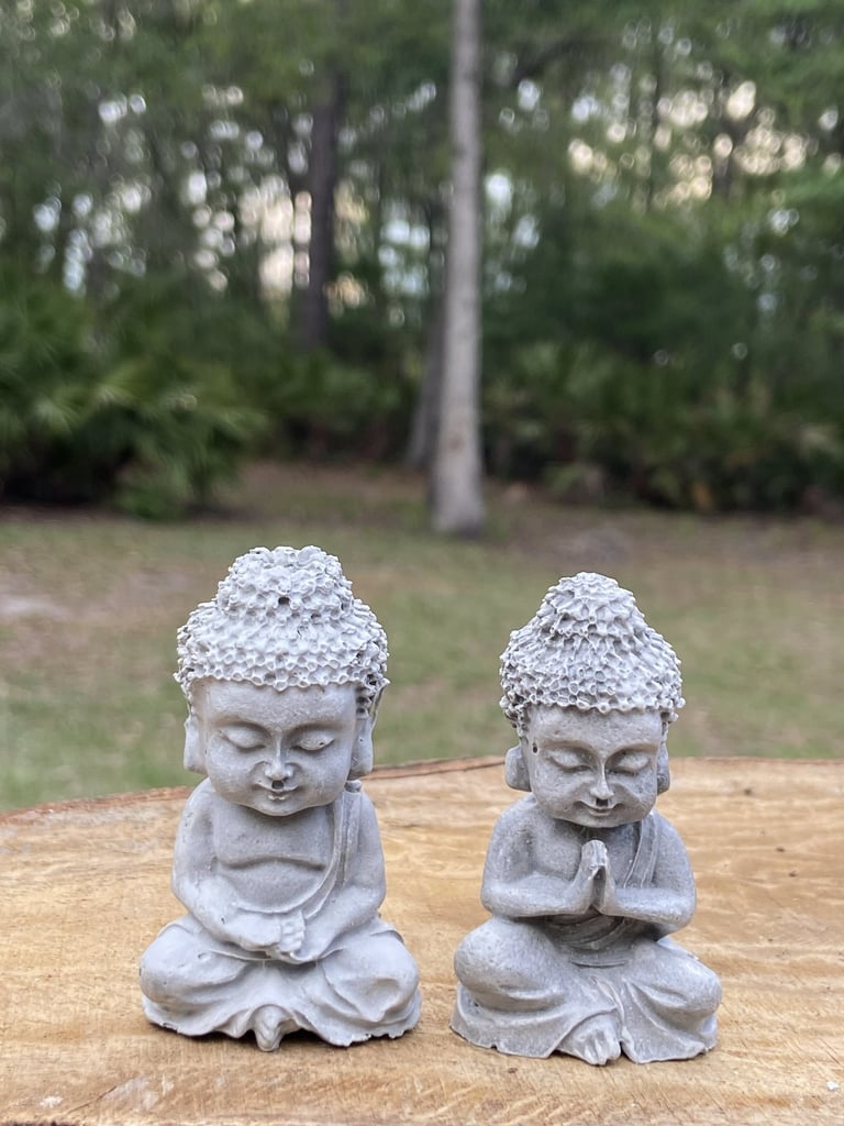 Two small stone Buddha statues.