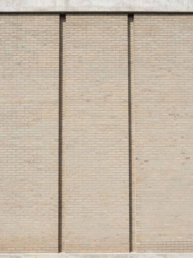 Straight-on architectural photograph of a renovated brick building facade, clean vertical lines, soft natural daylight, 35mm lens