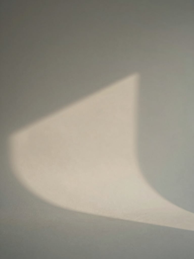 Minimalist studio portrait of a creative director in soft natural light, warm gray background, clean shadows, editorial photography style