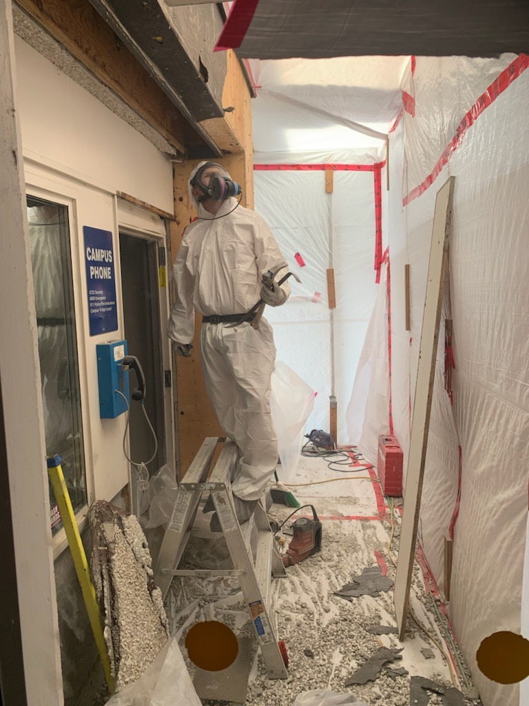 abatement worker removing asbestos
