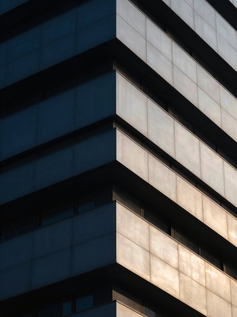 Abstract architectural geometry of a modern futuristic building corner, sharp lines, deep blue shadow and bright gold sunlight reflection, cool crisp focus