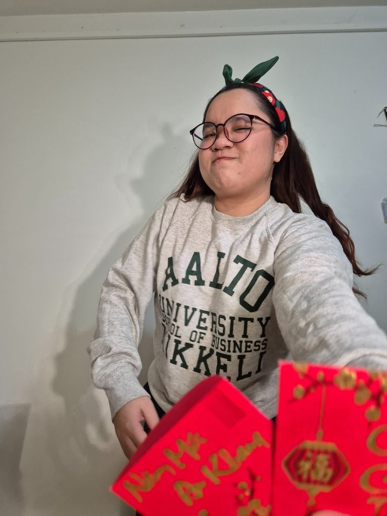 a woman in a grey Aalto university sweater