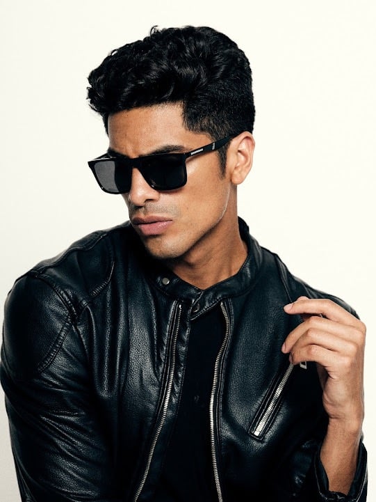 Dany Peña international male model in black leather jacket and sunglasses editorial portrait