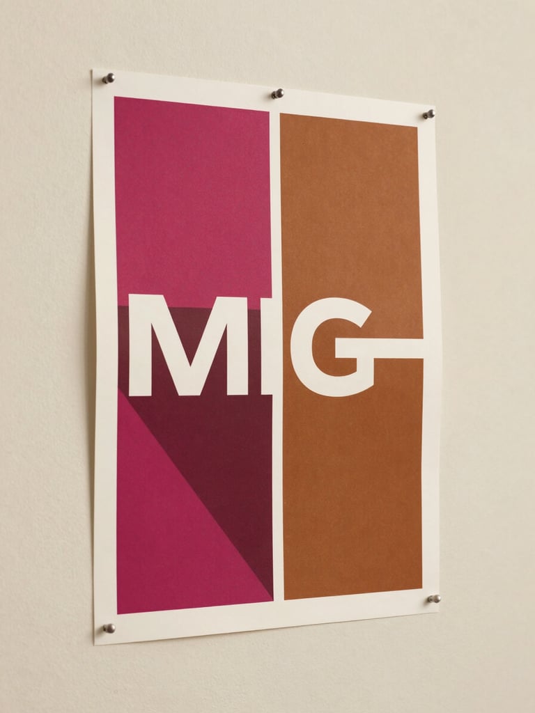 Close detail of a printed advertising campaign poster pinned to a cream studio wall, bold geometric forms in magenta and warm brown ink, sharp typographic hierarchy visible, soft diffused studio lighting, no hands, no person — the work alone filling the frame