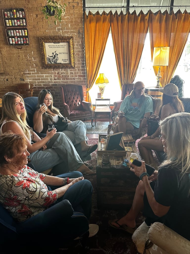 Fort Worth girls weekend ladies in a rustic lounge with brick walls, velvet chairs, and drinks.